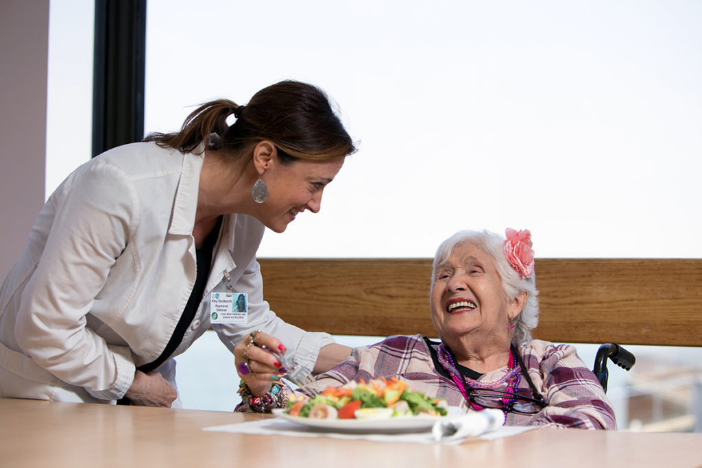 Nurse and patient celebrate her birthday with a cake